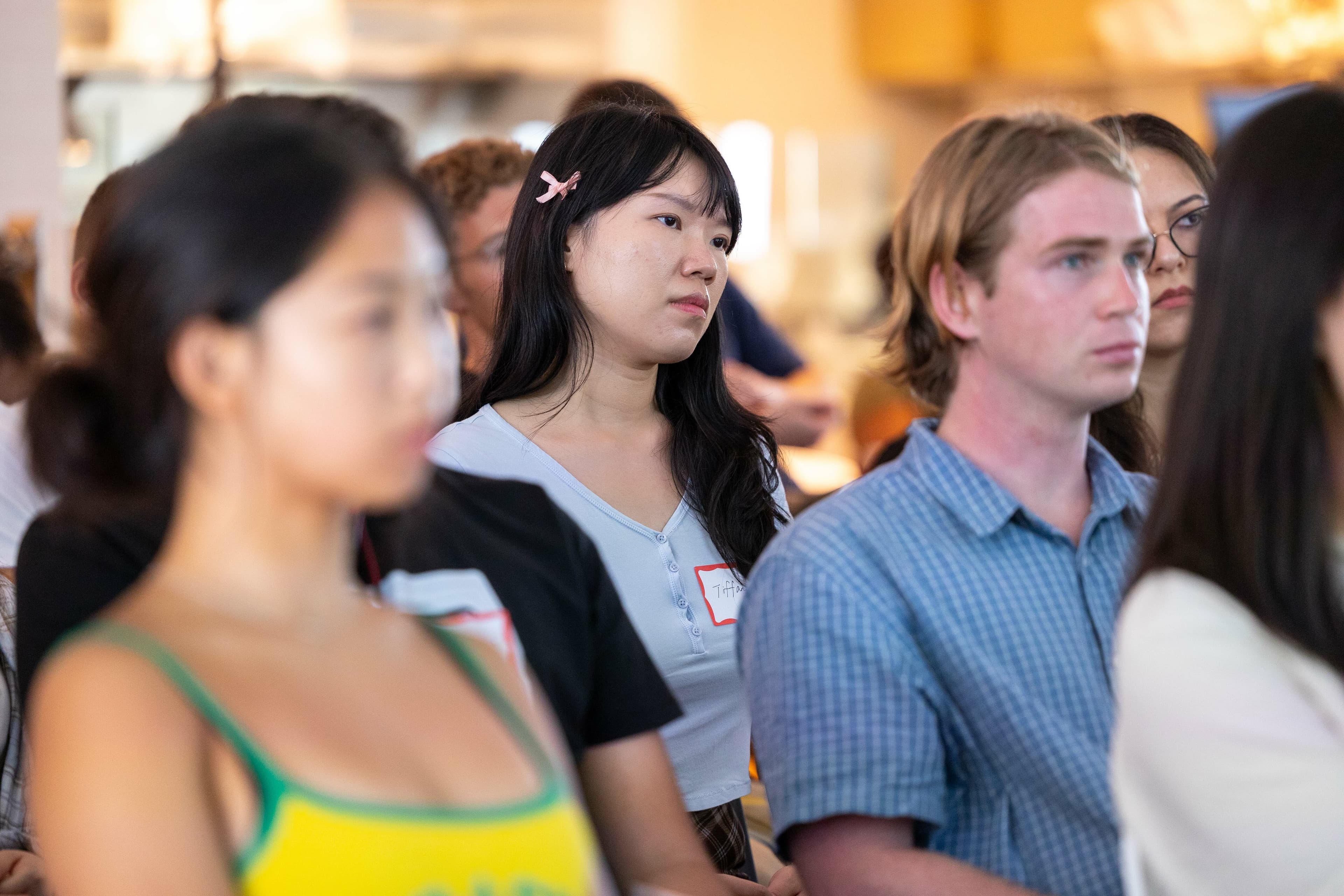 Students sit listening to a panel at Stanford Research Park. (Photo credits to Nikolas Liepins/Ethography for Stanford Summer Session)